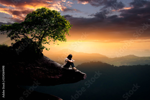 silhouette of a man sitting on a tree