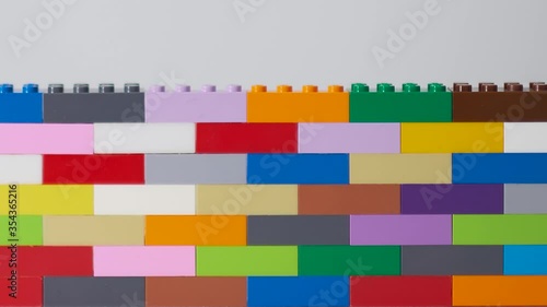 plastic building block. plastic brick wall. Wall from Plastic building blocks isolated. Suitable for greetings card, holidays. White background. stock footage. Close up video.