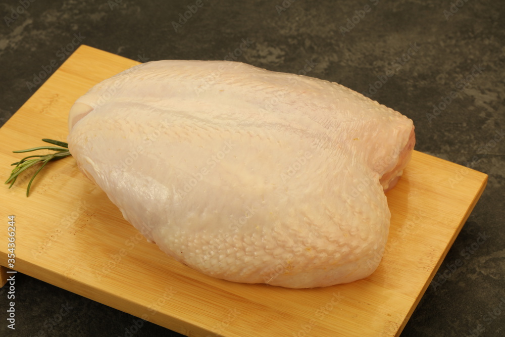 Raw whole chicken breast with skin Raw whole chicken breast with skin