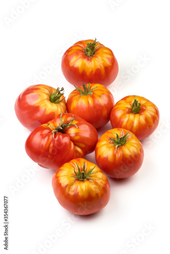 Fresh rustic tomatoes, isolated on white background