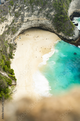 (Selective focus) View from above, stunning aerial view of a T-Rex shaped cliffs with the beautiful Kelingking Beach bathed by a turquoise sea. Nusa Penida, Indonesia.. photo