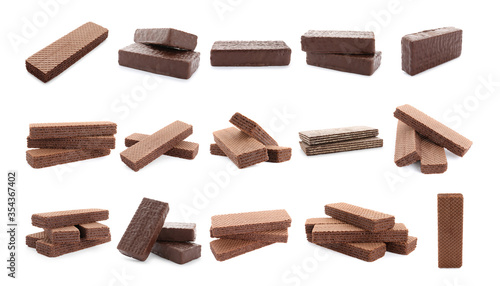 Set of different delicious crispy wafers on white background. Sweet food