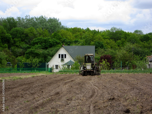 Plowed field by tractor in brown soil on open countryside nature