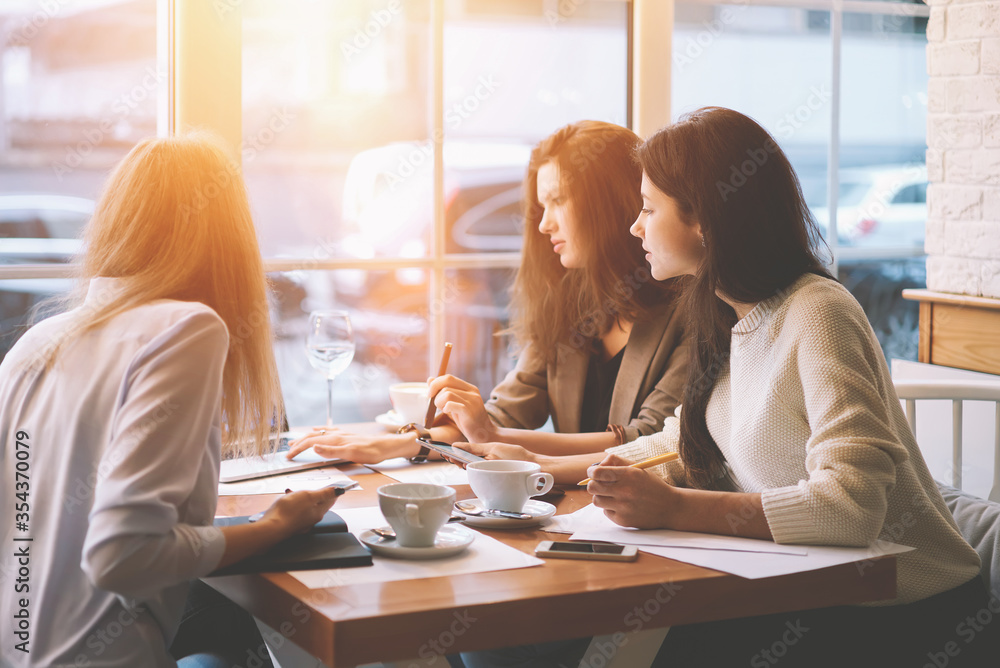 Modern three female colleagues brainstorming about work Modern three female colleagues brainstorming about work