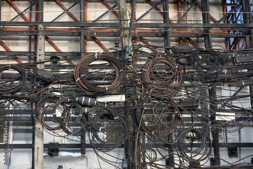 Many electric wires and internet cables are tied together on the electricity poles, which looks very chaotic and confusing. Which may cause danger or electric shock.