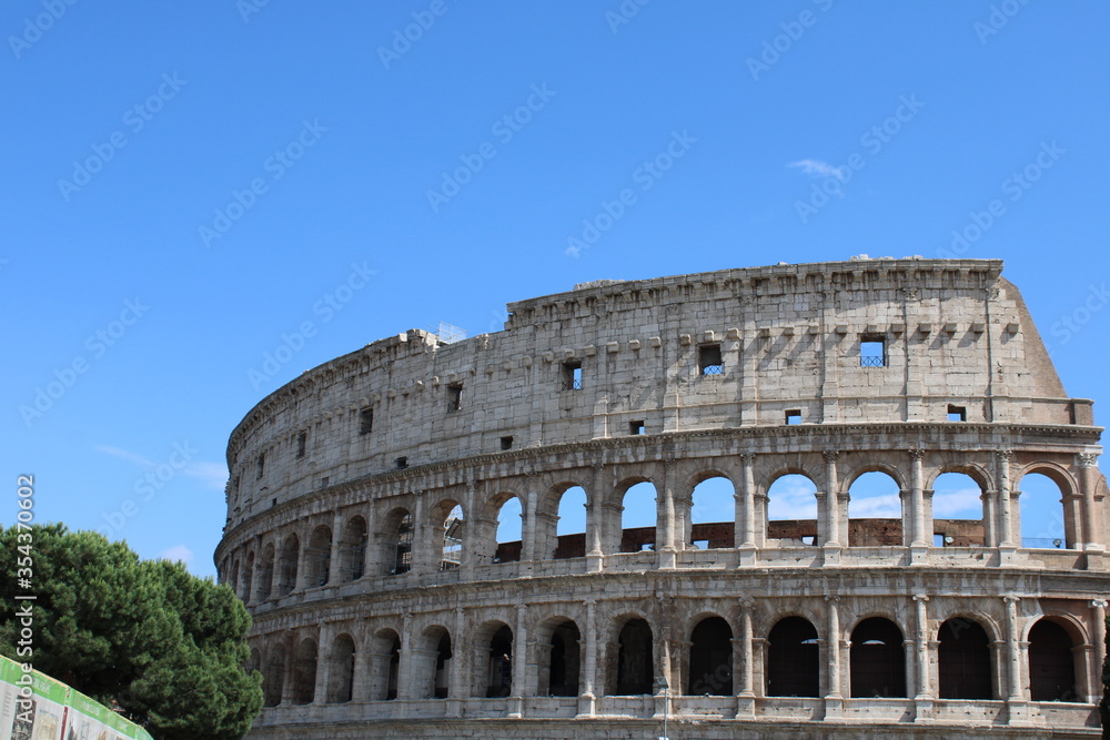colosseum with clear sky background in rome italy Colosseum in rome is among wonders of world and famous tourist destination and ancient amphitheater once used for gladiator fight 