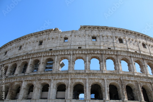 colosseum with clear sky background in rome italy Colosseum in rome is among wonders of world and famous tourist destination and ancient amphitheater once used for gladiator fight 