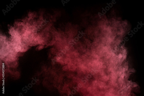 Red and pink powder explosion.Red and pink powder explosion on black background. Colored powder cloud. Colorful dust explode. Paint Holi.