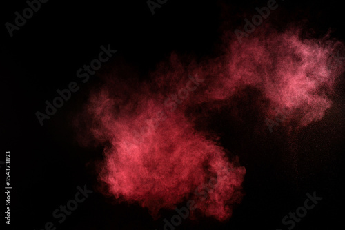 Red and pink powder explosion.Red and pink powder explosion on black background. Colored powder cloud. Colorful dust explode. Paint Holi.