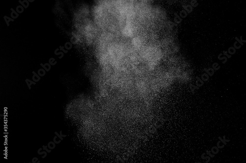 White powder explosion on black background. Abstract white dust texture.