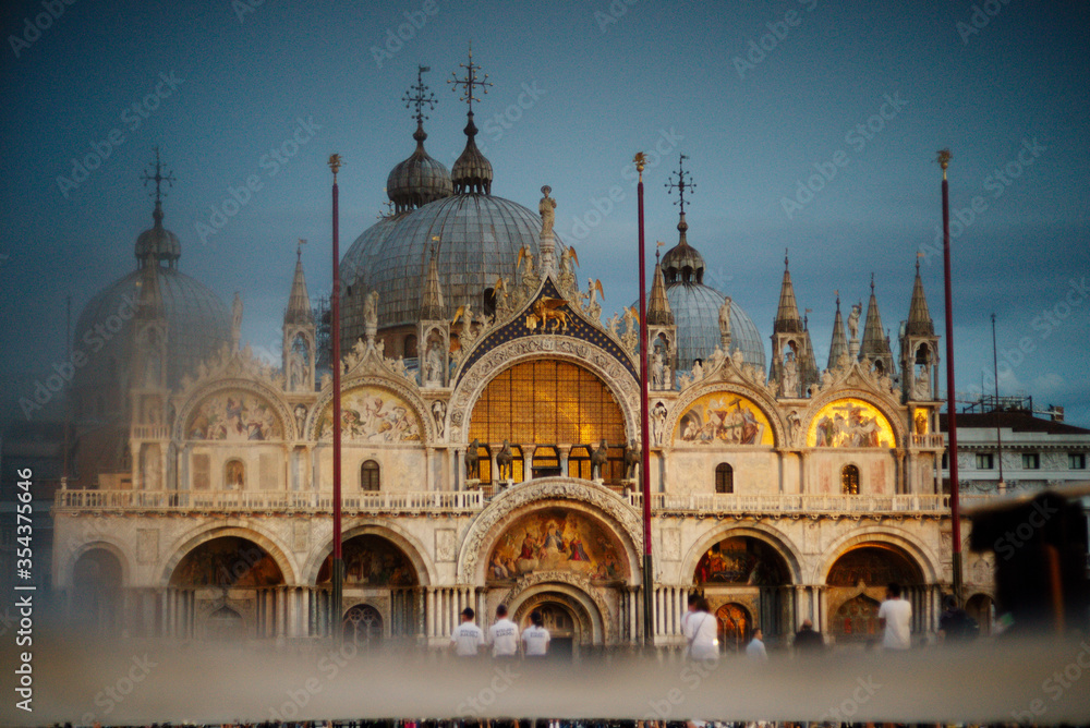 Tourists in the square in front of St. Mark's Cathedral in the evening. St. Mark's Basilica in the evening,Venice, Italy.