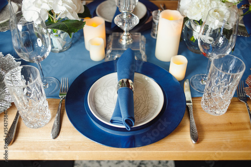 Beautifully served table with dishes and flowers. High quality photo