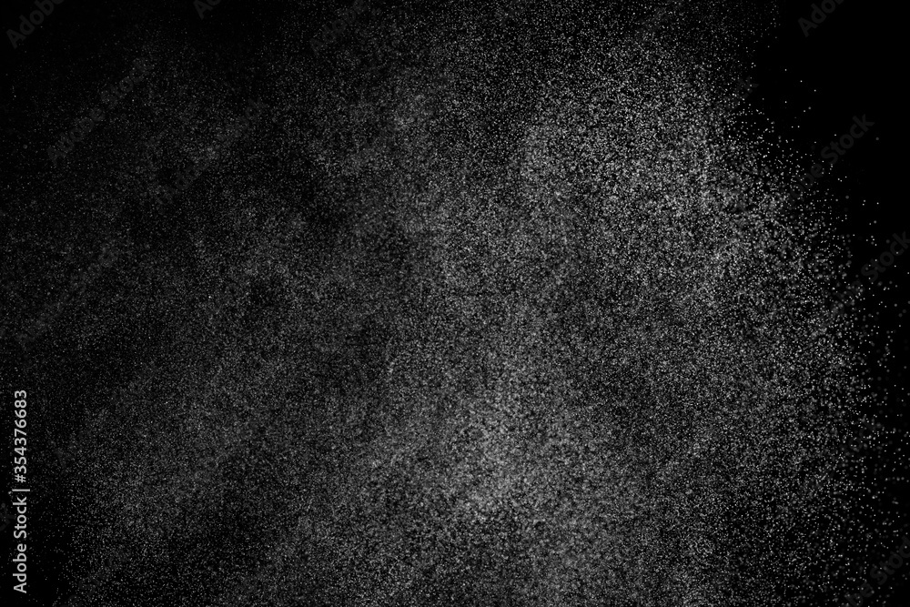 Abstract splashes of water on black background. Freeze motion of white particles. Rain, snow overlay texture. Abstract splashes of water on black background. Freeze motion of white particles. Rain, snow overlay texture.
