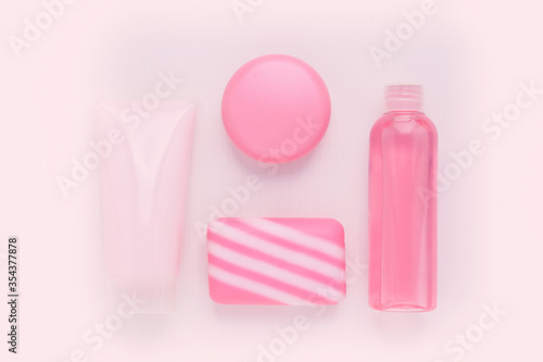 Cosmetics for beauty and skin care, makeup. Cleansing tonic, moisturizing and nourishing cream with collagen and lifting effect, blush, natural soap on a pink background © yta