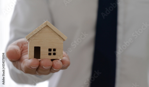 Real estate agent or House sales representatives present house models.