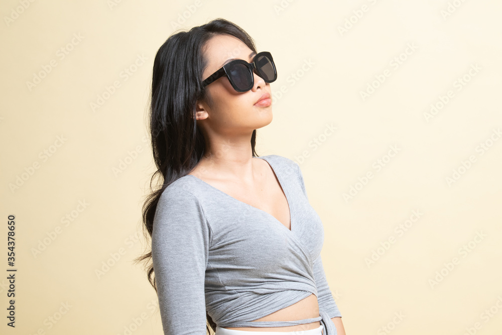 Portrait of a beautiful young asian girl in sunglasses. Portrait of a beautiful young asian girl in sunglasses.