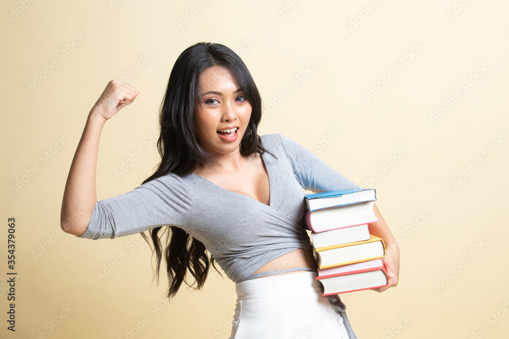 Young Asian woman studying with may books. Young Asian woman studying with may books.