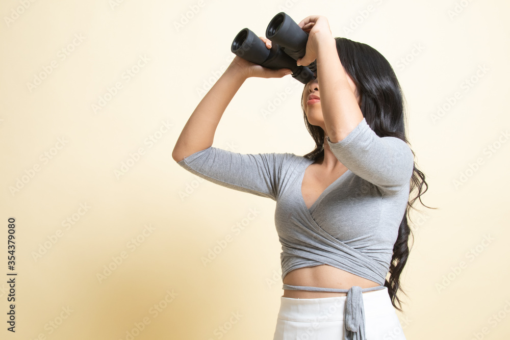 Young Asian woman with binoculars. Young Asian woman with binoculars.