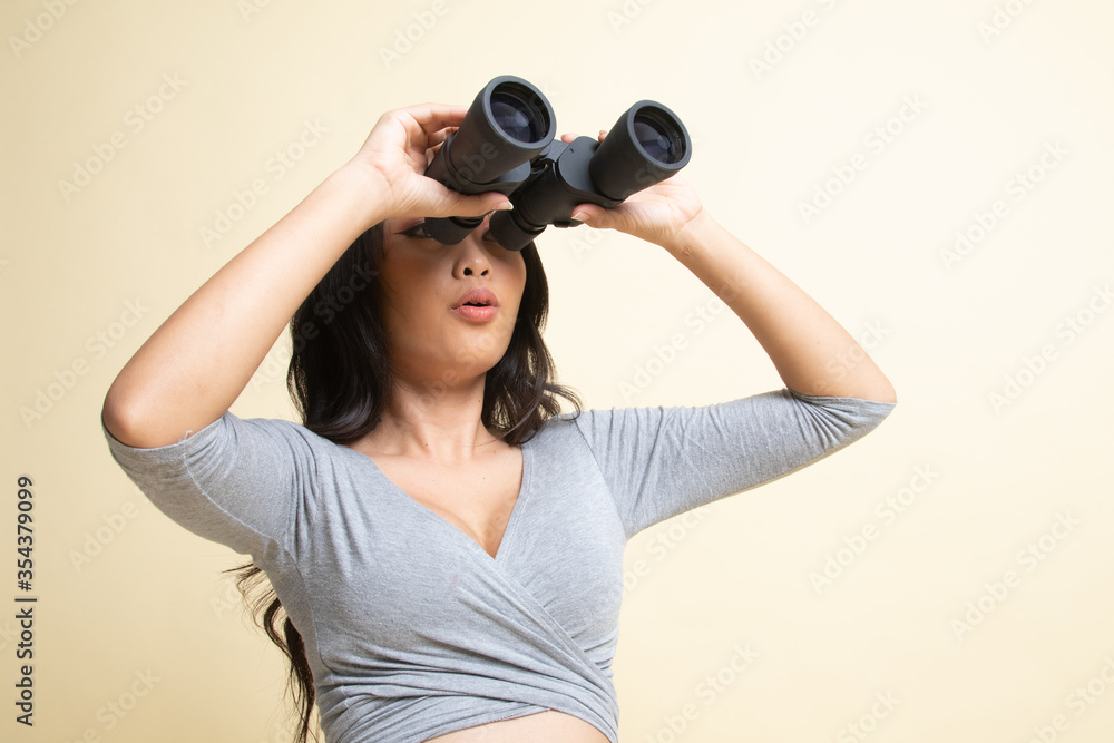Young Asian woman with binoculars. Young Asian woman with binoculars.
