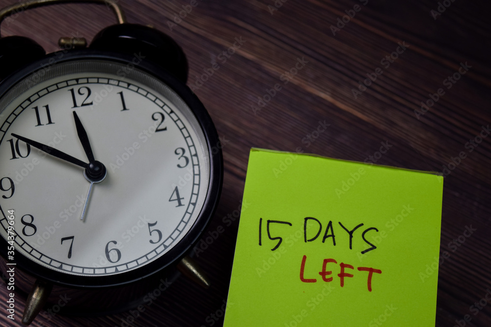 15 Days Left write on sticky note isolated on wooden table. 15 Days Left write on sticky note isolated on wooden table.