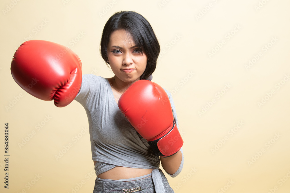 Young Asian woman with red boxing gloves. Young Asian woman with red boxing gloves.