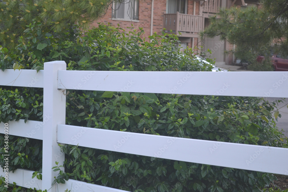 White Fence in Front of a Apartment Complex White Fence in Front of a Apartment Complex