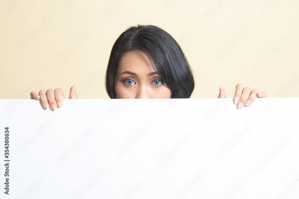 Close up of young Asian woman behind a blank sign. Close up of young Asian woman behind a blank sign.