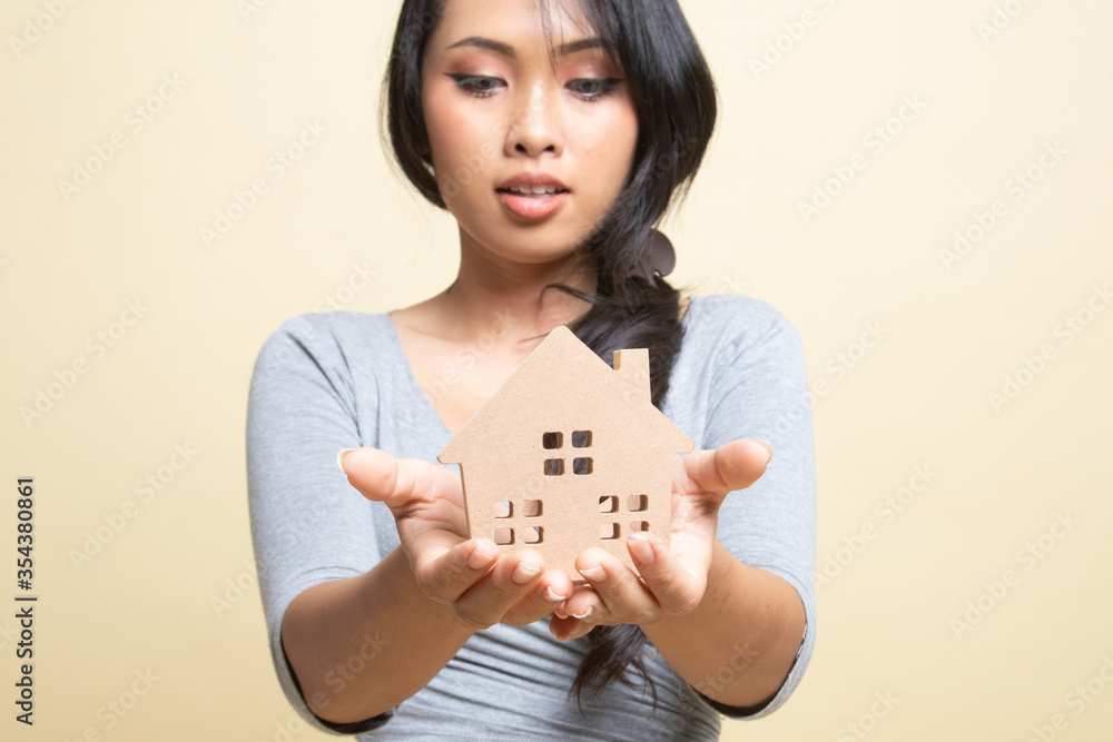 Happy young asian woman with house model. Happy young asian woman with house model.