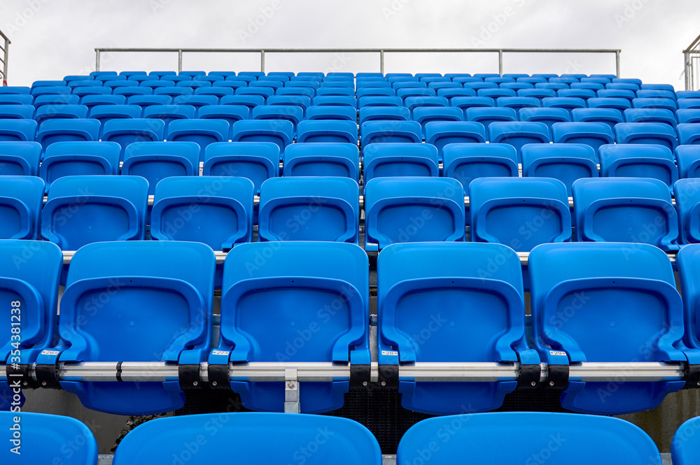 Naklejka premium Blue plastic seats at the tribune