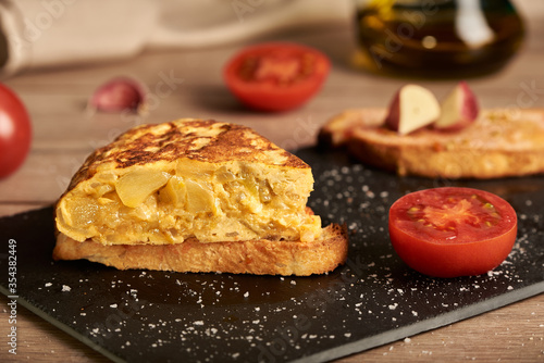Tableau sur toile A classic tortilla de patatas, potato omelette snack on a slice of bread