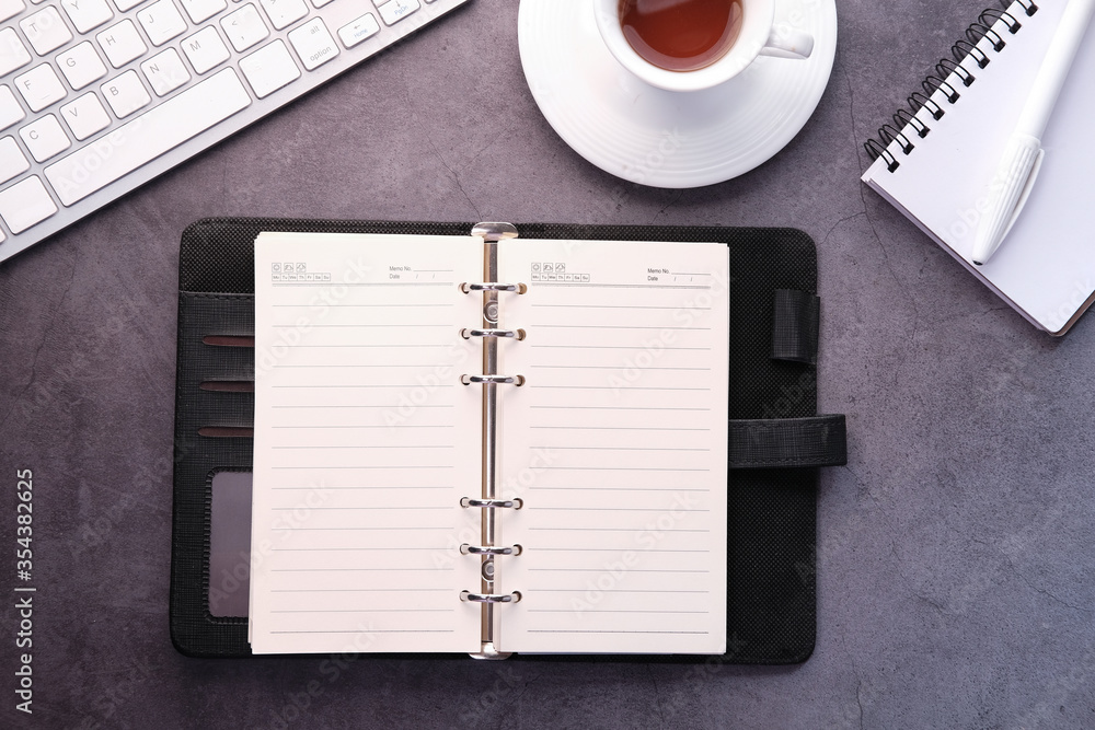 open diary, keyboard and tea on table open diary, keyboard and tea on table