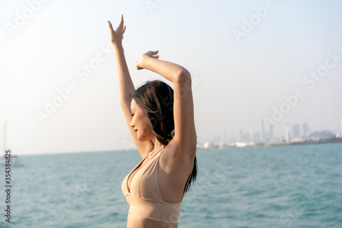 Asian Woman Sexy in Luxurious Bikini Relaxing on Yacht in the Sea.