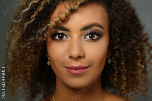 Portrait of cute woman that standing on grey background