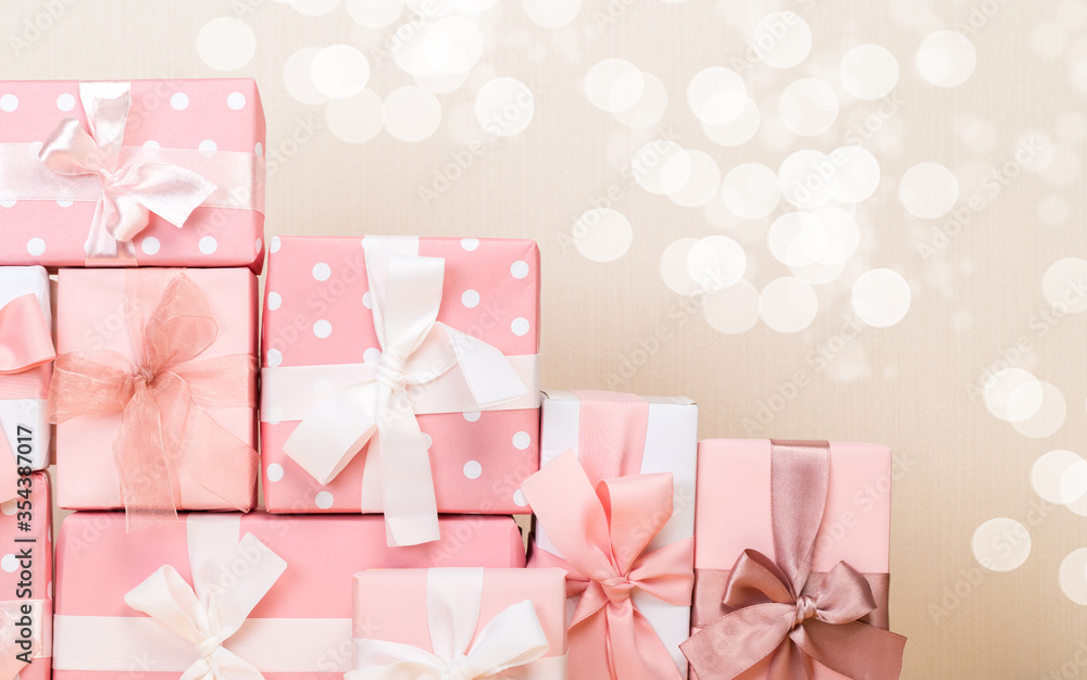 Group of gifts on a wooden table. Gift boxes with bows. beige background