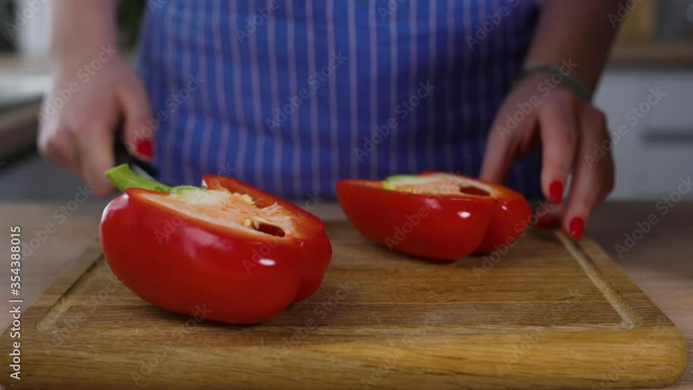 slicing red pepper on the wooden table for cooking slicing red pepper on the wooden table for cooking