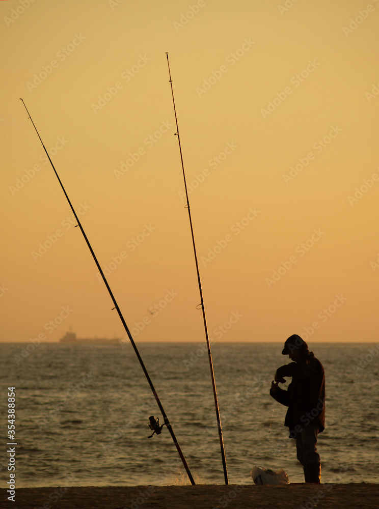 A fisherman fishing at sunset, Povoa de Varzim, Braga, Portugal.