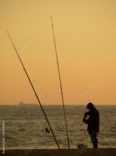 A fisherman fishing at sunset, Povoa de Varzim, Braga, Portugal.
