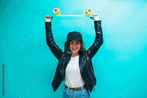 Valokuva Young trendy pretty girl wearing black leather jacket, white blank t-shirt, blue