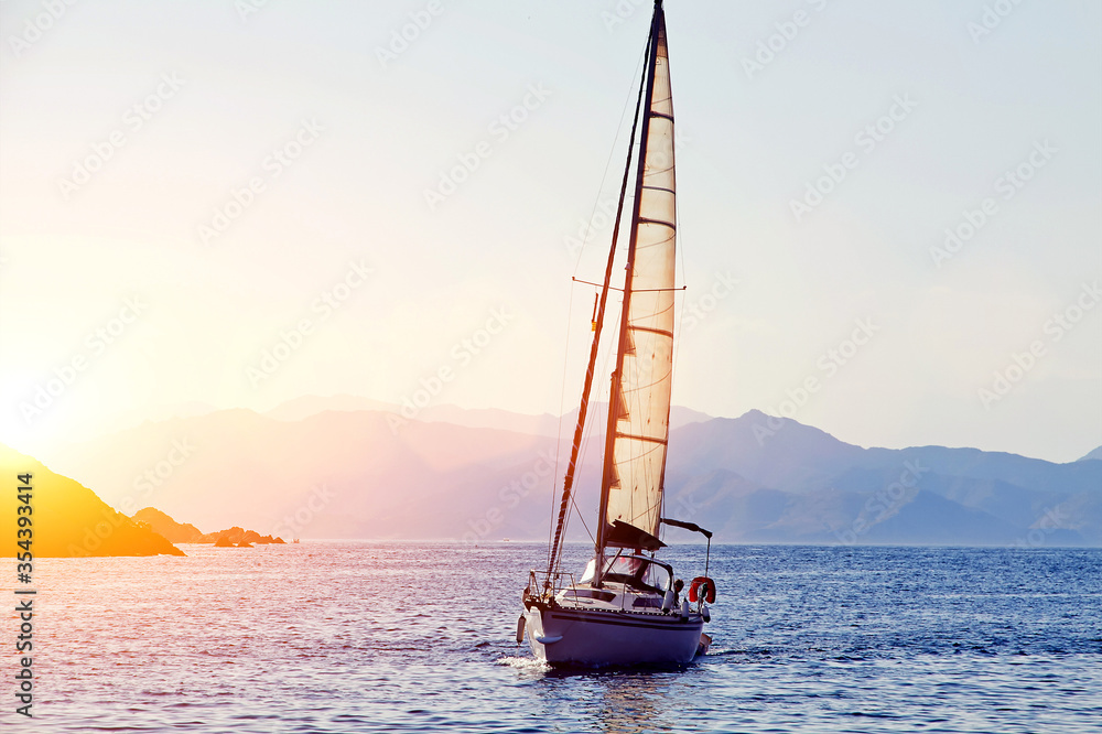 Naklejka premium sailing ship in sea during beautiful sunset