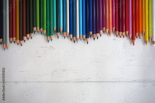 wooden background with colored pencils