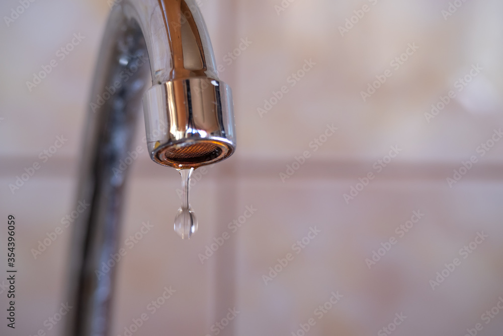 Close-up drop of water from a faucet Close-up drop of water from a faucet