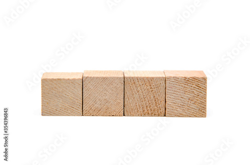 Wooden cubes on a white background. Four identical cubes lie, stand in a row together and separately, directly and at an angle. Place for text