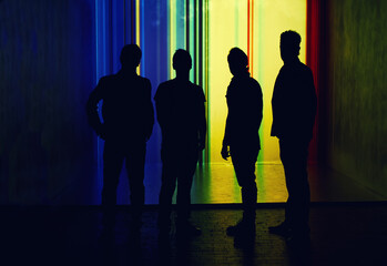 Silhouette of four people, unrecognised person in full length