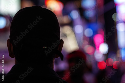 silhouette of man walking in city at night 