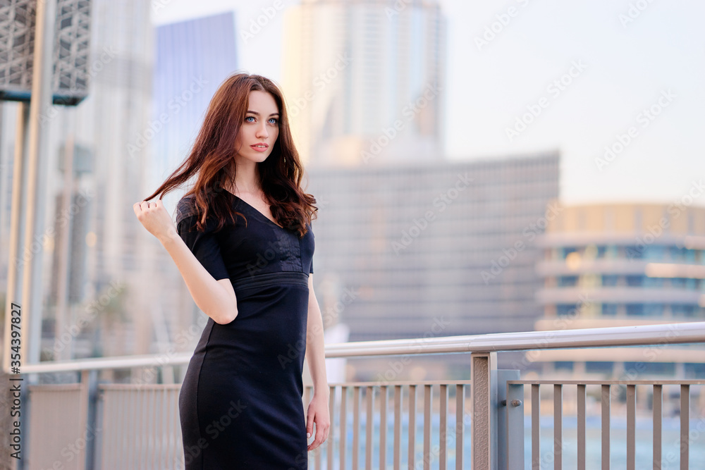 Portrait of beautiful caucasian woman with charming smile and long hair walking on the Dubai street. Portrait of beautiful caucasian woman with charming smile and long hair walking on the Dubai street.