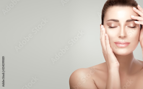 Beautiful serene woman with fresh clean skin. Heathy skin girl aplying facial treatment. Skincare concept photo