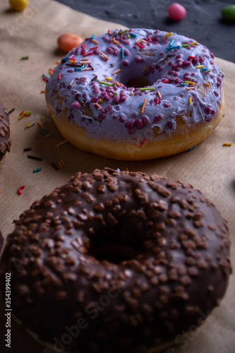 Donuts on a wooden board on a blue concrete background