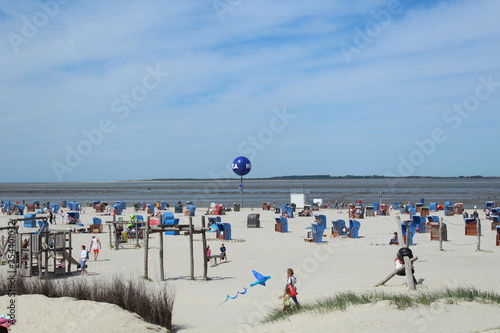 the beach in Dornumersiel, Germany, with beach chairs