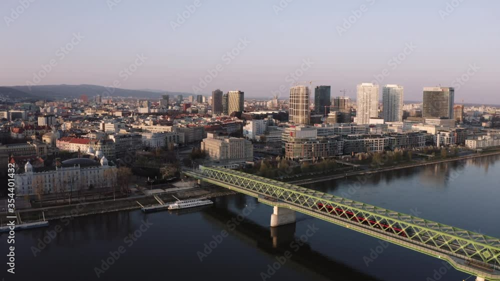 Aerial shot Red trams on Old green bridge over danube river in Bratislava Capital of Slovakia Aerial shot Red trams on Old green bridge over danube river in Bratislava Capital of Slovakia