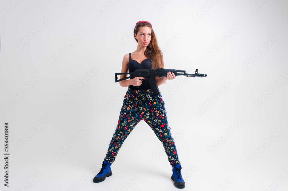 Strong young woman with a gun, picture isolated on white background Strong young woman with a gun, picture isolated on white background